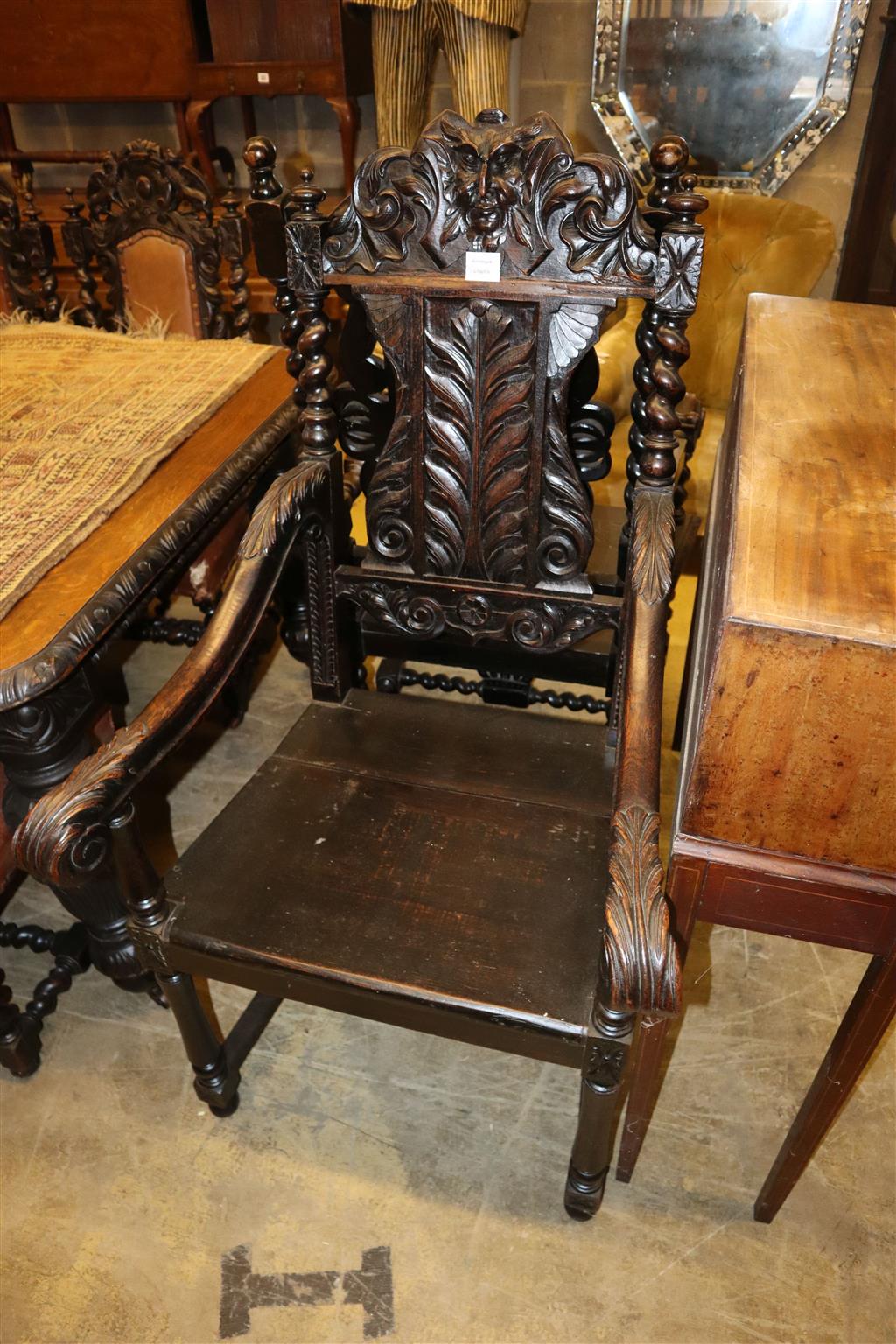 A near pair of Flemish carved oak elbow chairs, larger width 65cm x depth 60cm, height 126cm